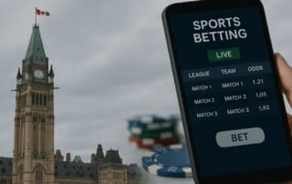 Hand holding smartphone displaying sports betting app with Parliament Hill Peace Tower in background, representing Canada's Bill S-211 advertising regulations