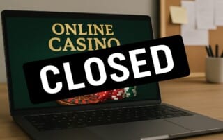 Laptop displaying online casino with CLOSED sign representing Golden Billy Casino shutdown