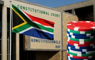 South African Constitutional Court building in Pretoria with national flag and casino chips representing freeplay tax ruling 1280x720 image
