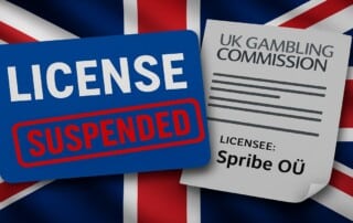 UK Gambling Commission suspends Spribe OÜ license with red suspended stamp over blue license card against Union Jack flag background