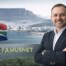 Cameron Green appointed as Amusnet Country Manager for South Africa with Table Mountain and South African flag in background