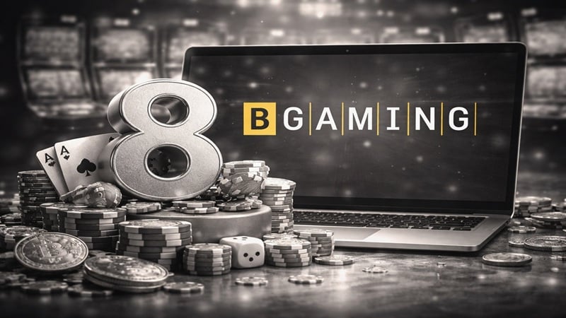 BGaming 8th anniversary celebration featuring the number 8, casino chips, playing cards, dice, and a laptop displaying the BGaming logo.