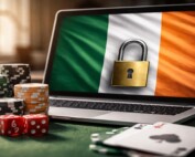 Laptop displaying Irish flag with padlock symbol alongside casino chips, dice, and playing cards representing Ireland's new GRAI online gambling licensing system launching February 202