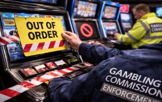 Gambling Commission officer removing non-compliant slot machine under new UK gaming machine enforcement rules