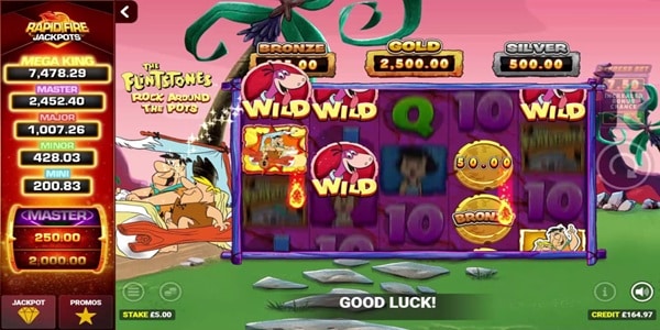 The Flintstones Rock Around The Pots Slot Game | Blueprint Gaming – Weekly Review The Flintstones Rock Around The Pots slot reels with Wilma Flintstone, wild symbols and card royals, beneath the bronze, gold and silver pot meters.