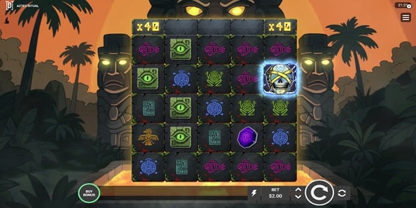 Aztec Ritual Slot Game | Degen Studios – Weekly Review Aztec Ritual slot 5x5 grid with stone tablet symbols including a green eye, blue turtle, gold snake medallion, and pink fish, beneath a top row of silver and gold multiplier tiles